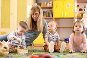 nursery-teacher-looking-children-daycare-little-kids-toddlers-play-together-developmental-toys-kindergarten-146176318